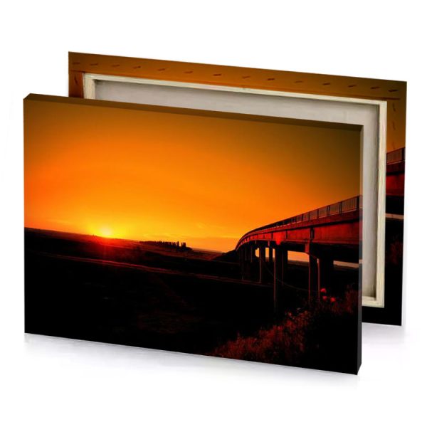 a train is traveling over bridge at sunset dark orange canvas - Image 4
