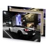 a white car driving down the street at night medium purple canvas - Image 4