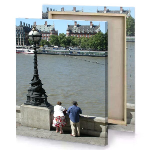 a couple of people sitting on bench by river manatee canvas - Image 4