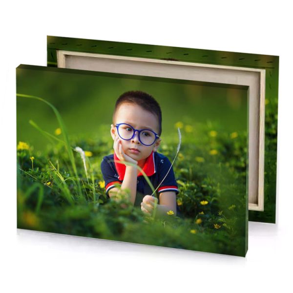 a little boy wearing glasses and sitting in the grass hunter green canvas - Image 4
