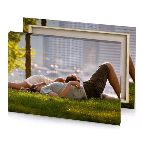 a man and woman laying on the grass rose quartz canvas - Image 4
