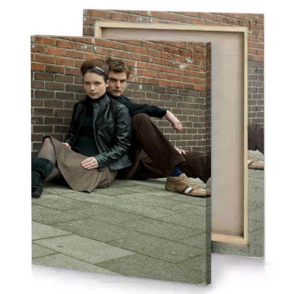 a man and woman sitting on the ground camouflage green canvas - Image 4