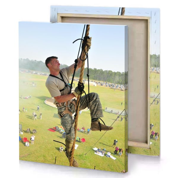 a man in camouflage gear is hanging on rope tan canvas - Image 4