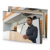 a man in suit standing at podium tan canvas - Image 4