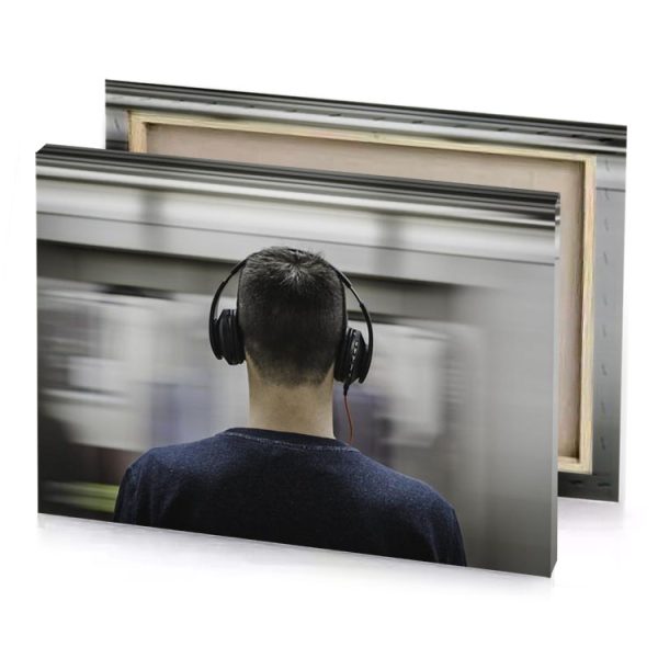 a man wearing headphones while standing in subway station smoky black canvas - Image 4