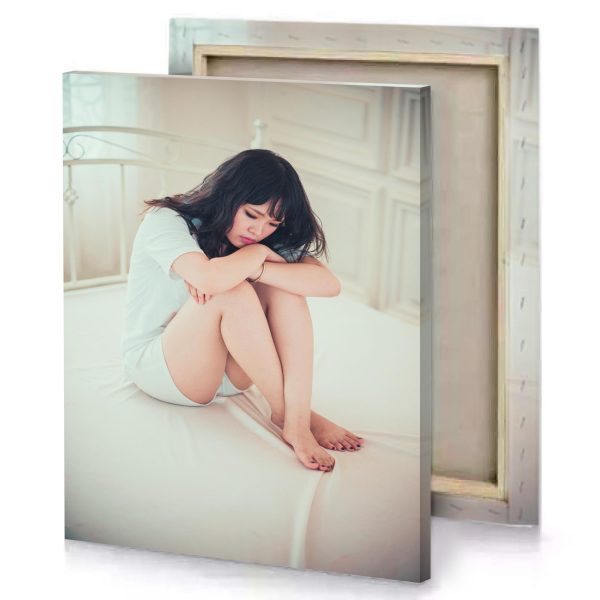 a woman sitting on bed with her head knees silver canvas - Image 4