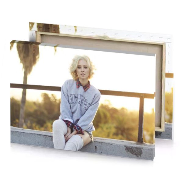 a woman sitting on wall with her legs crossed snow canvas - Image 4