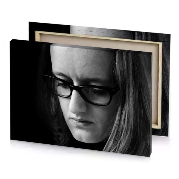 a woman with glasses looking down at her phone smoky black canvas - Image 4