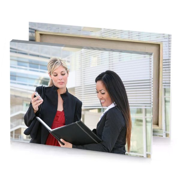 two women in business attire looking at a tablet platinum canvas - Image 4