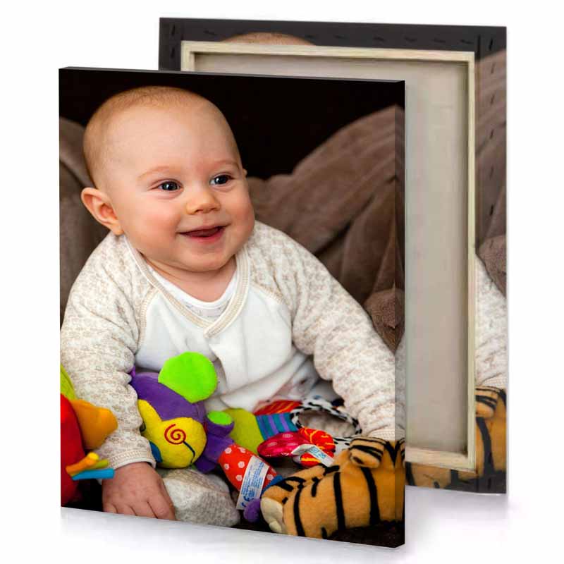 a baby sitting on couch with stuffed animals platinum canvas