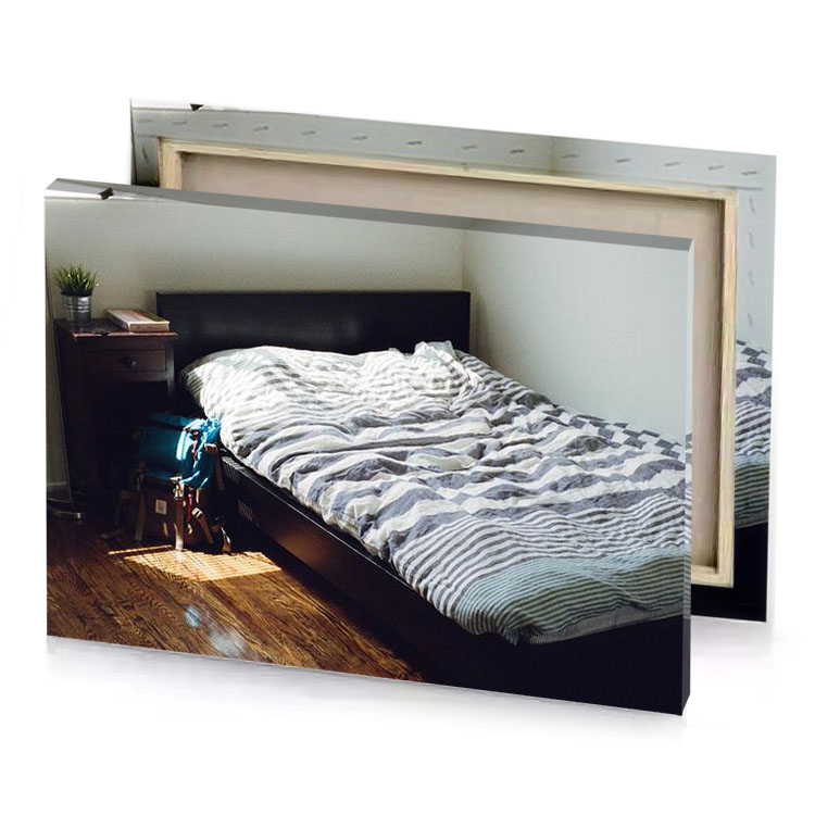 a bed with striped comforter and small dog platinum canvas