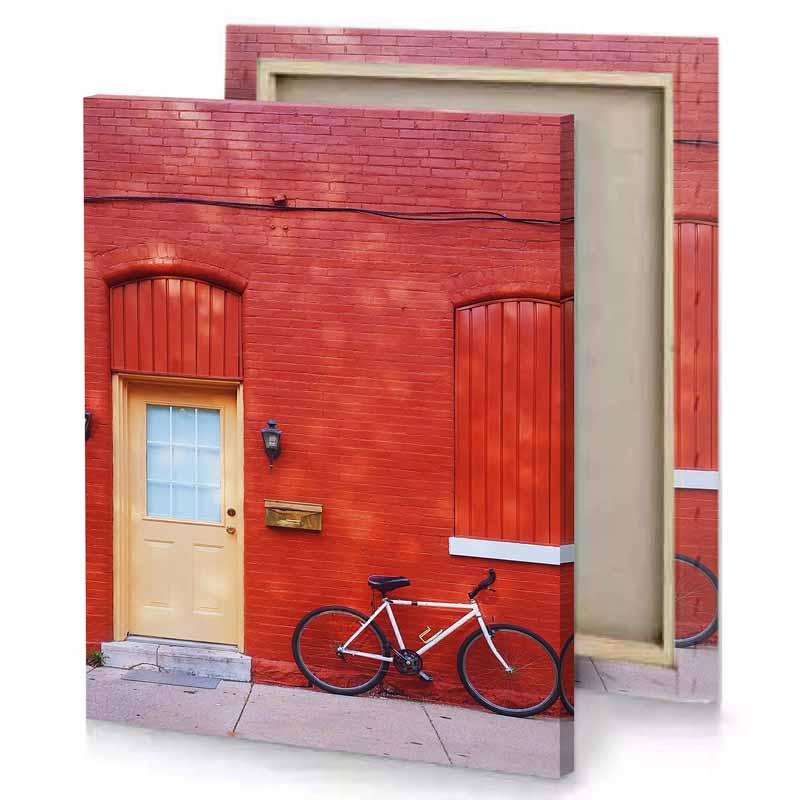 a bicycle parked in front of red brick building vermilion canvas