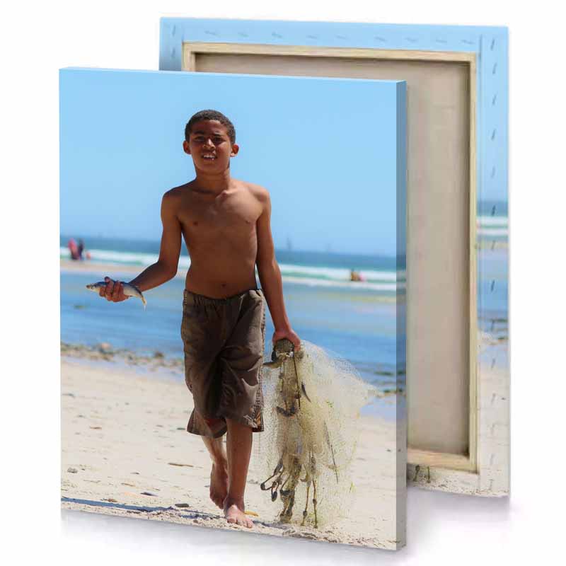 a boy walking on the beach with fish baby blue canvas