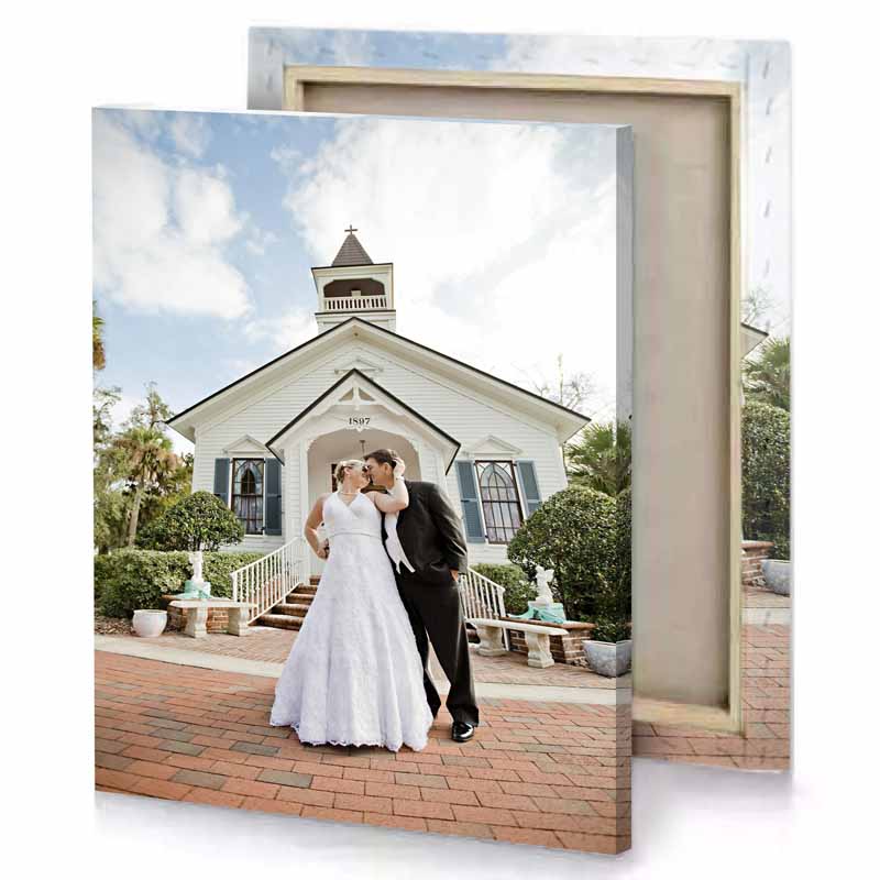 a bride and groom kissing in front of church silver canvas