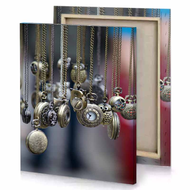 a bunch of necklaces hanging from rack gray canvas