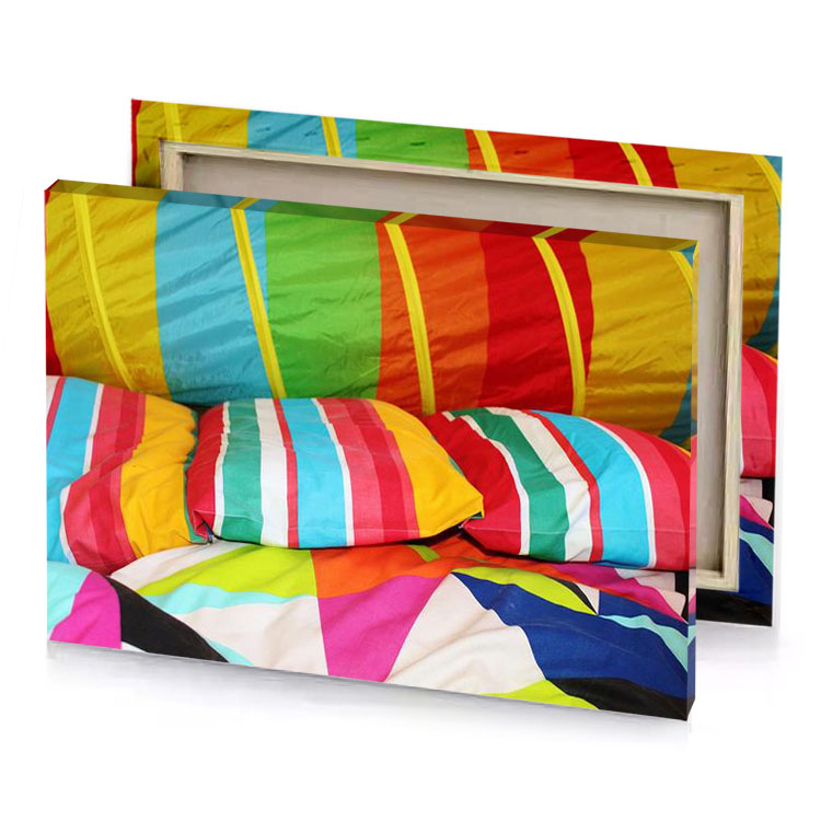 a colorful bed with pillows and mahogany canvas