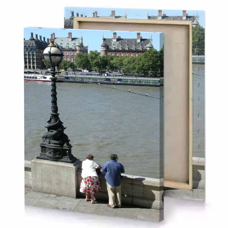 a couple of people sitting on bench by river manatee canvas