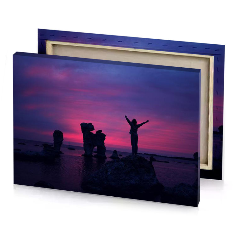 a couple of people standing on rocks in the water dim gray canvas