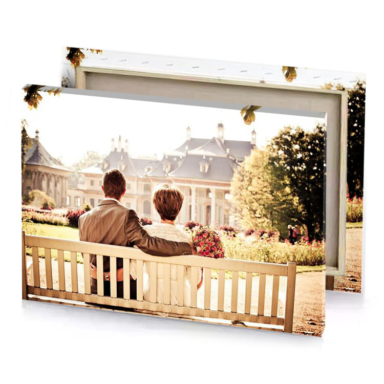 a couple sitting on bench in park bisque canvas