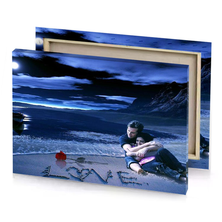 a couple sitting on the beach at night sapphire canvas
