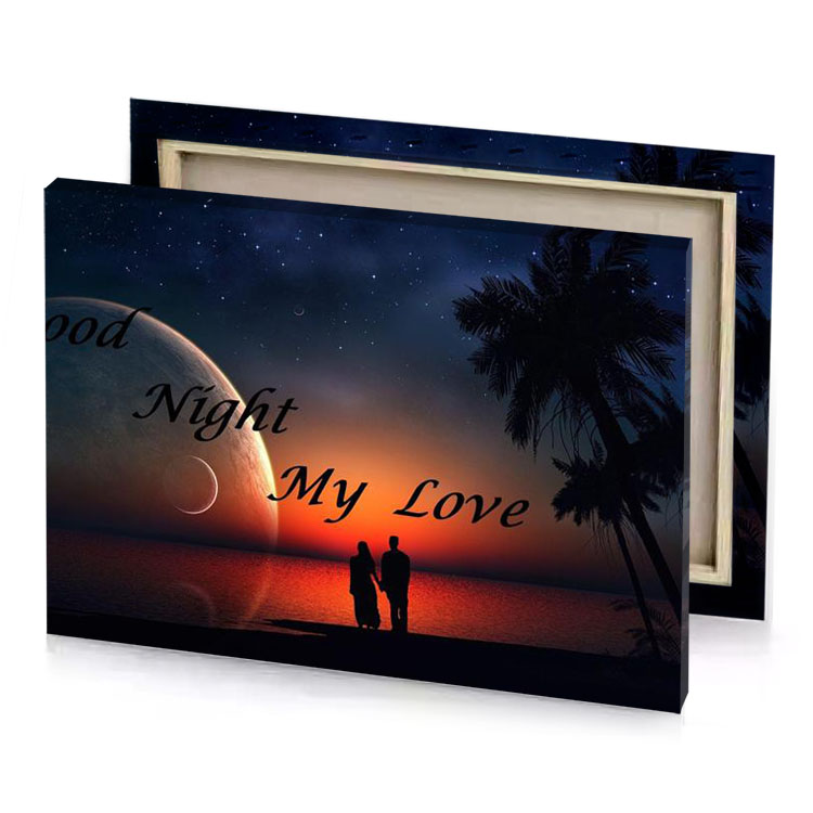 a couple standing on the beach with sun setting behind copper canvas