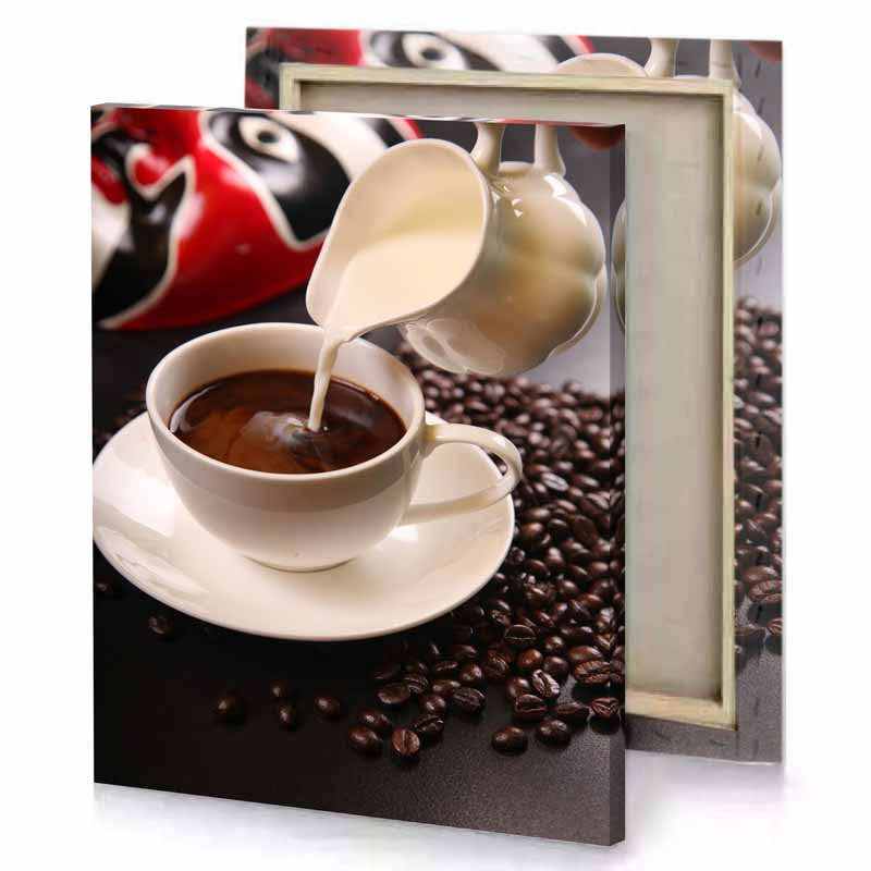 a cup of coffee being poured into silver canvas