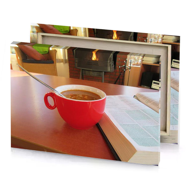 a cup of soup on table with book and spoon firebrick canvas
