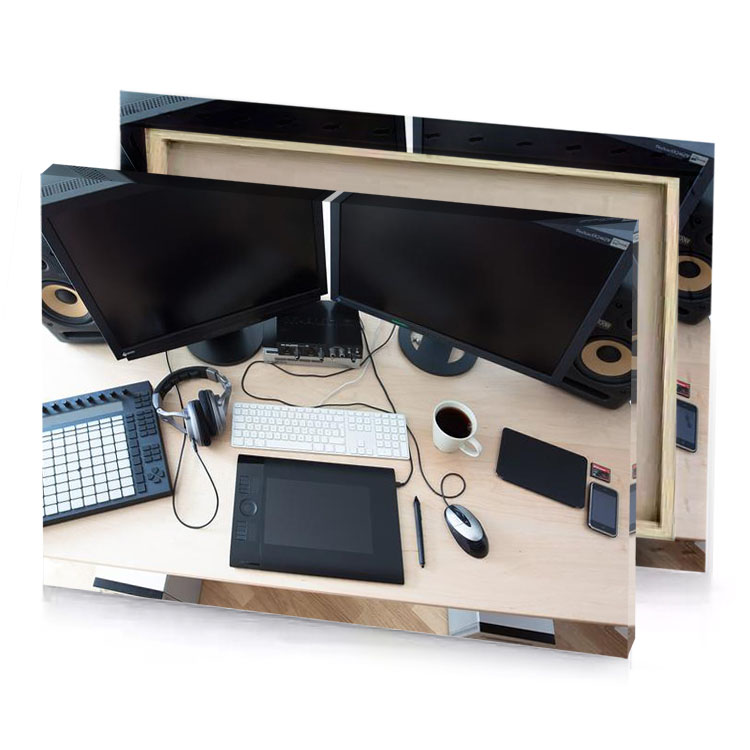 a desk with computer keyboard mouse and silver canvas