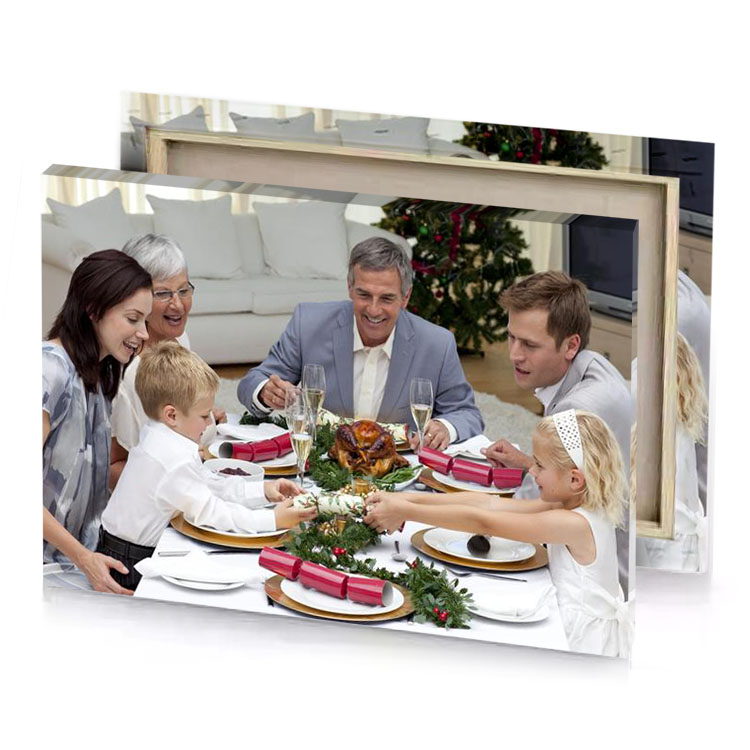a family sitting at table for christmas dinner linen canvas