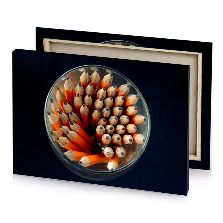 a glass filled with pencils and bunch of orange firebrick canvas