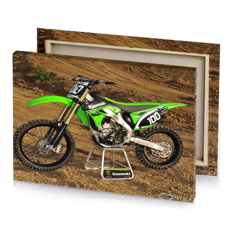 a green dirt bike parked on track yellow canvas