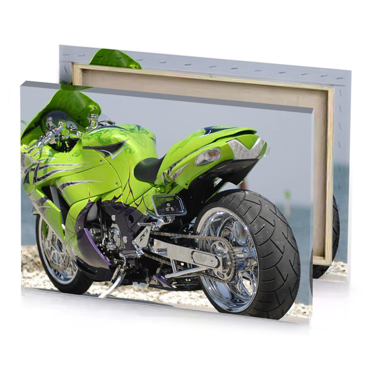 a green motorcycle parked on the beach yellow canvas