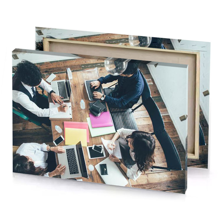 a group of people sitting around table with laptops plum canvas