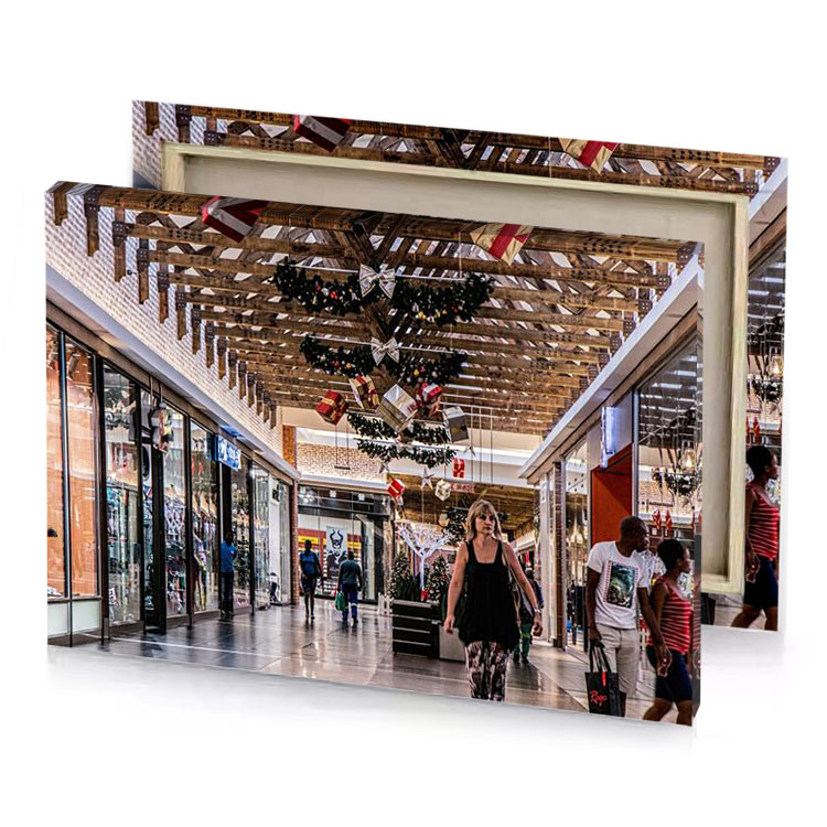a group of people walking down shopping mall garnet canvas