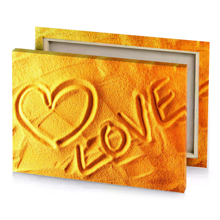 a heart in the sand with word love written on yellow orange canvas