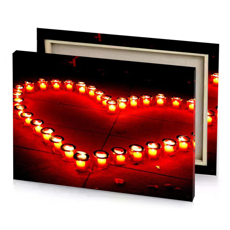 a heart made out of candles on the ground maroon canvas