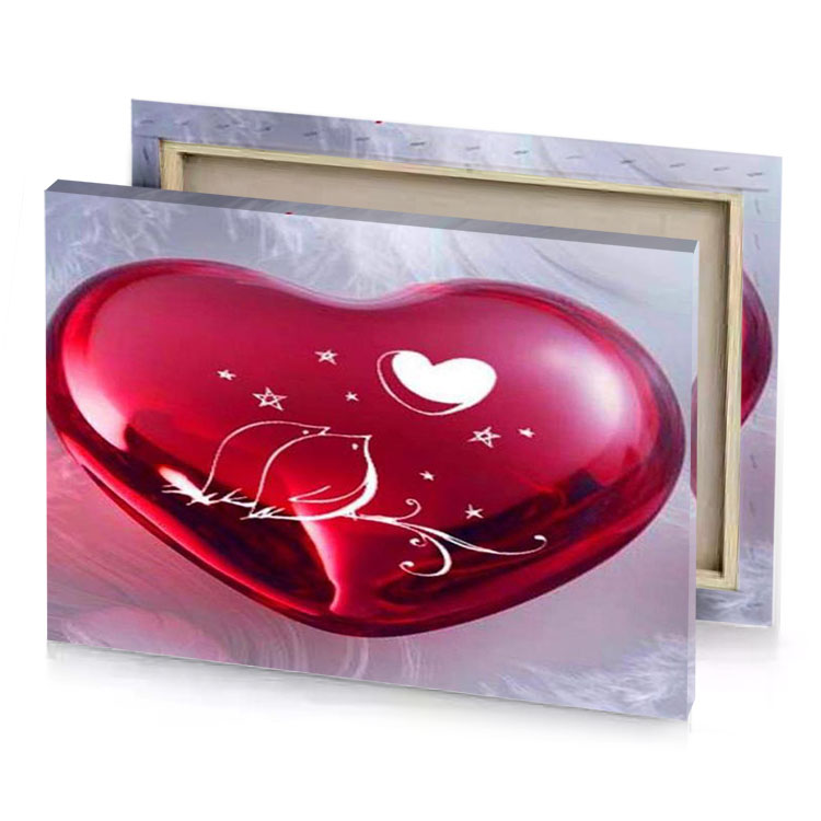 a heart shaped glass orname with star and moon design brown canvas