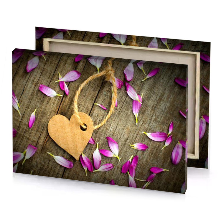 a heart shaped tag surrounded by petals on wooden surface fawn canvas