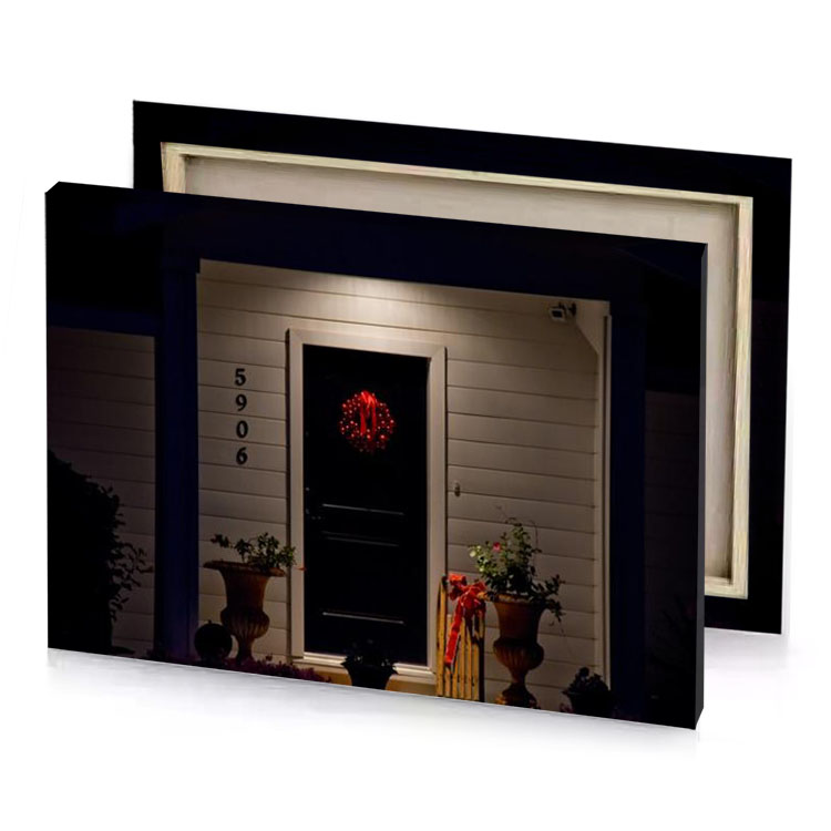 a house with lighted front door and wreath on the dark olive green canvas