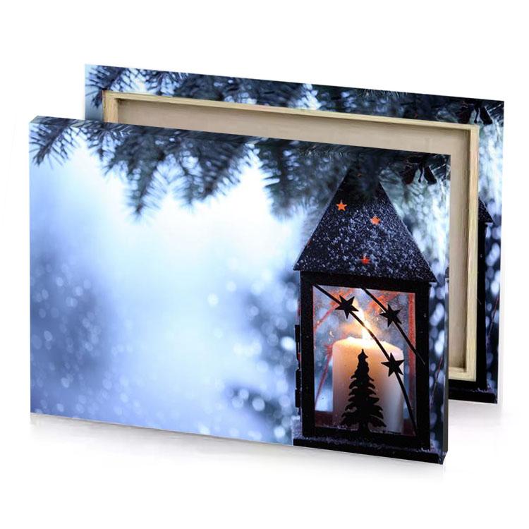 a lantern hanging from tree with candle lavender canvas