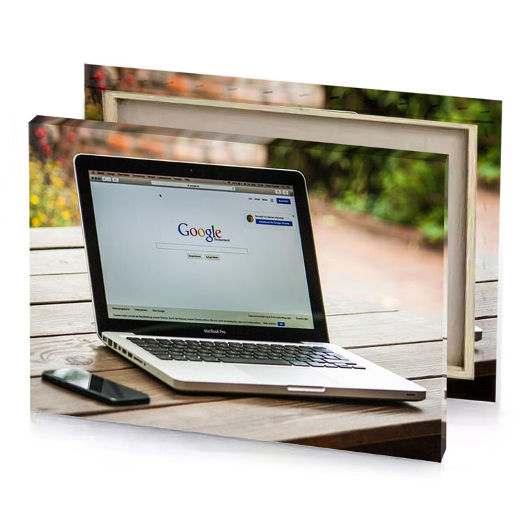 a laptop computer sitting on wooden table silver canvas