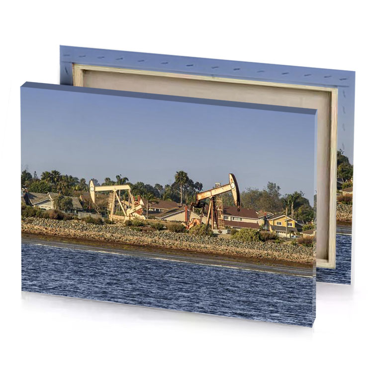 a large crane is on the shore of body water camouflage green canvas