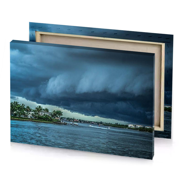 a large storm cloud is coming over body of water charcoal canvas