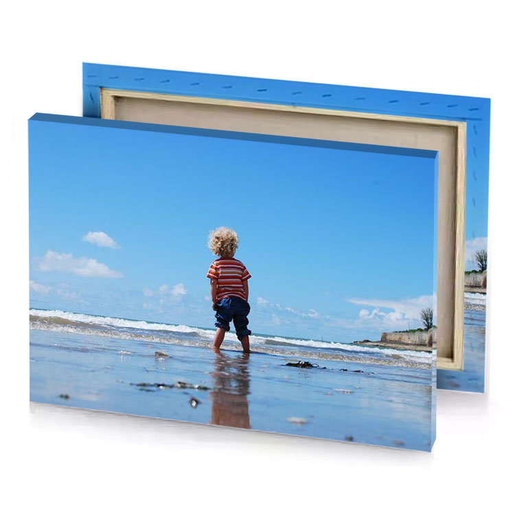 a little boy standing on the beach looking at ocean sky blue canvas