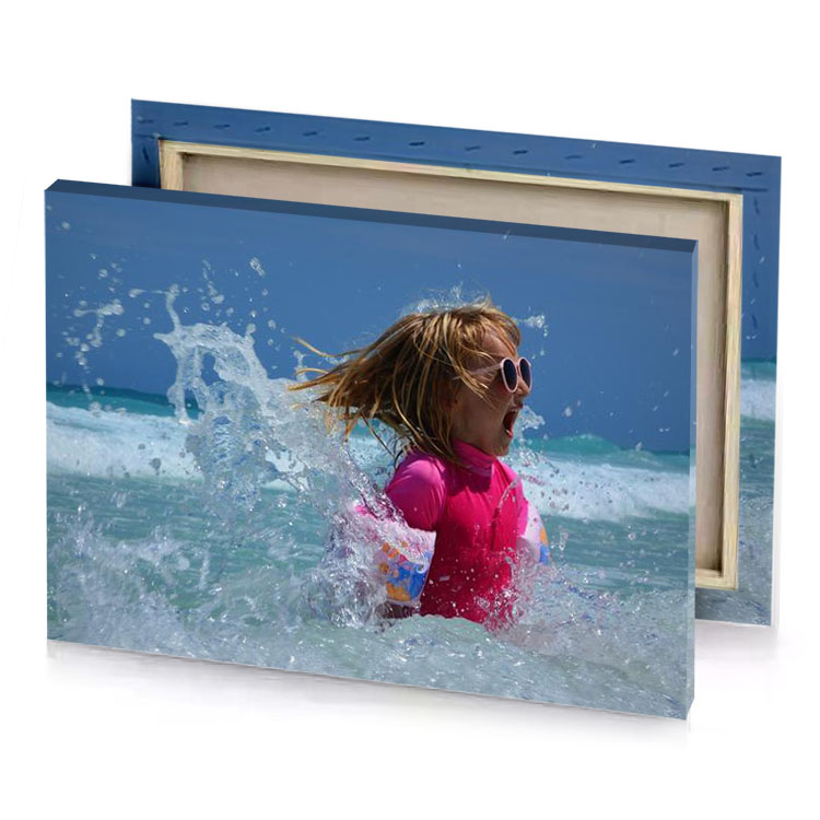 a little girl in the ocean with her hair blowing brown canvas