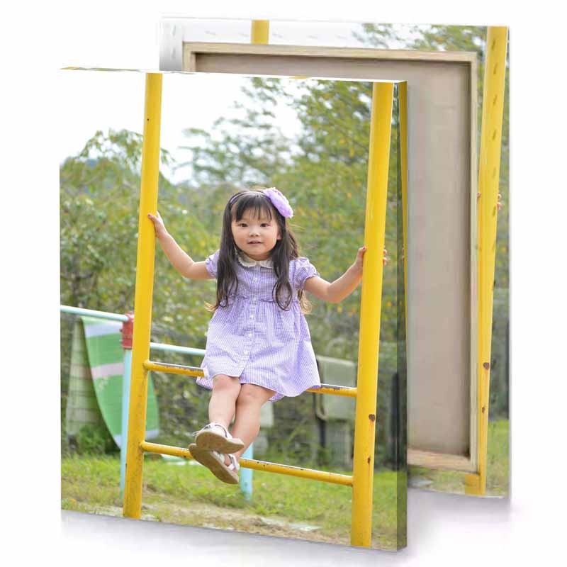 a little girl is sitting on swing yellow orange canvas