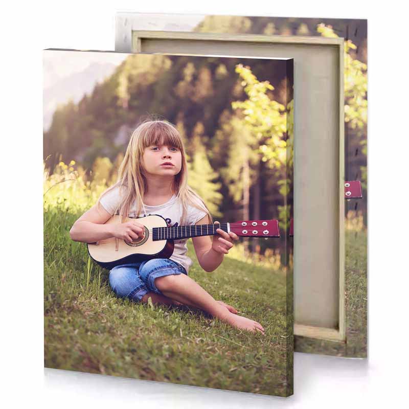 a little girl sitting on the grass playing guitar camouflage green canvas