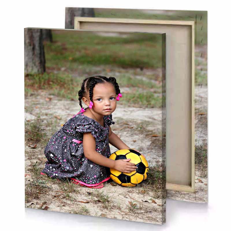 a little girl sitting on the ground with soccer ball camouflage green canvas