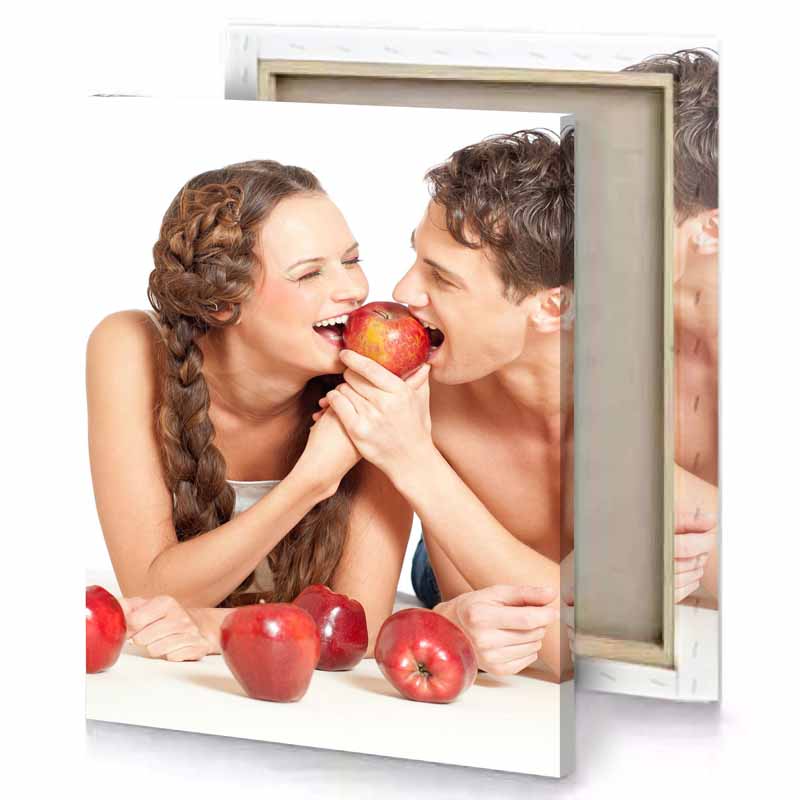 a man and woman are eating apples together snow canvas
