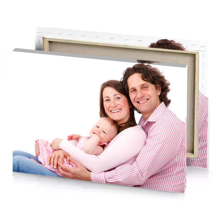 a man and woman holding baby snow canvas